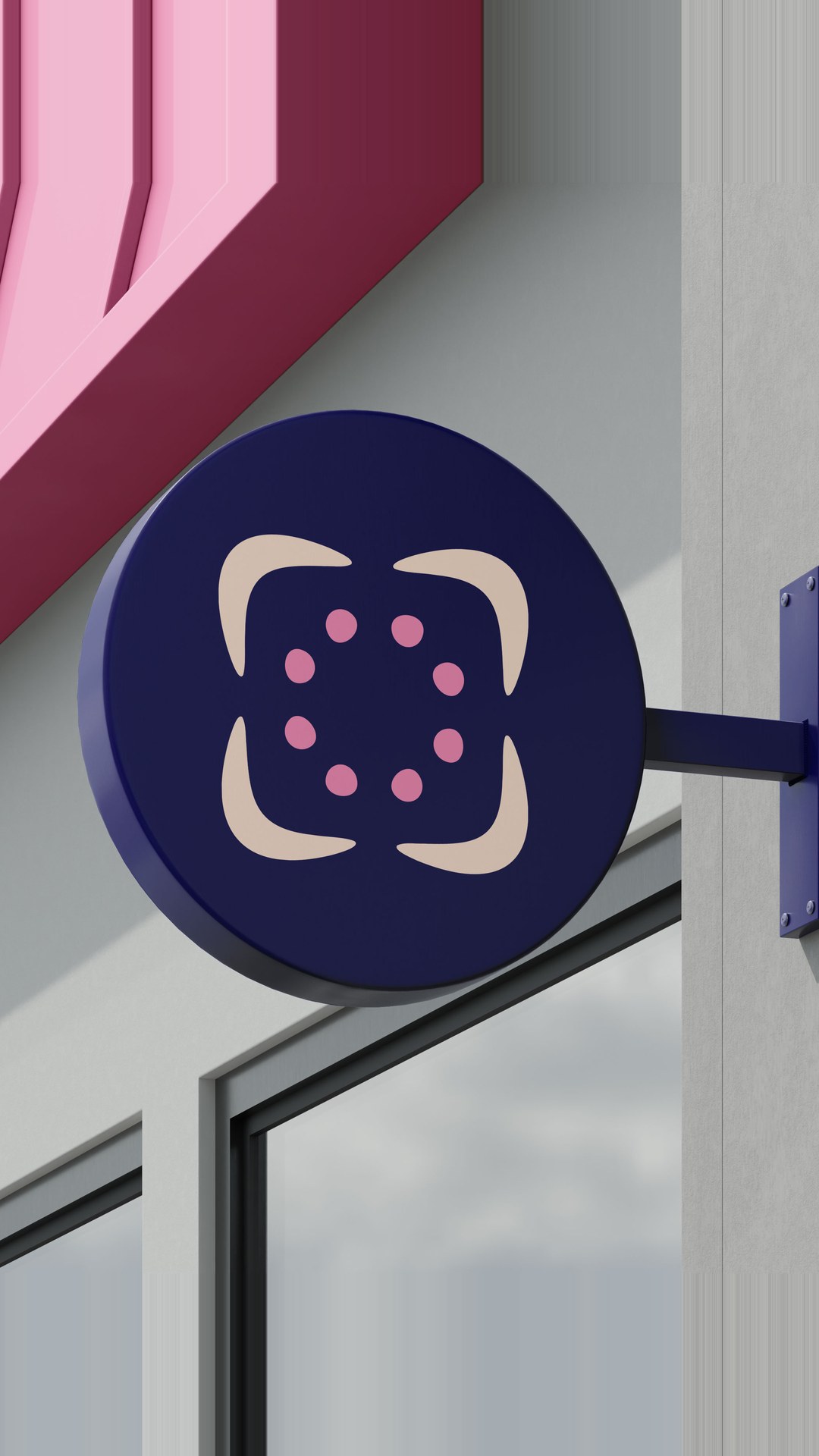 Round blade sign with the Chosen Family mark on a building