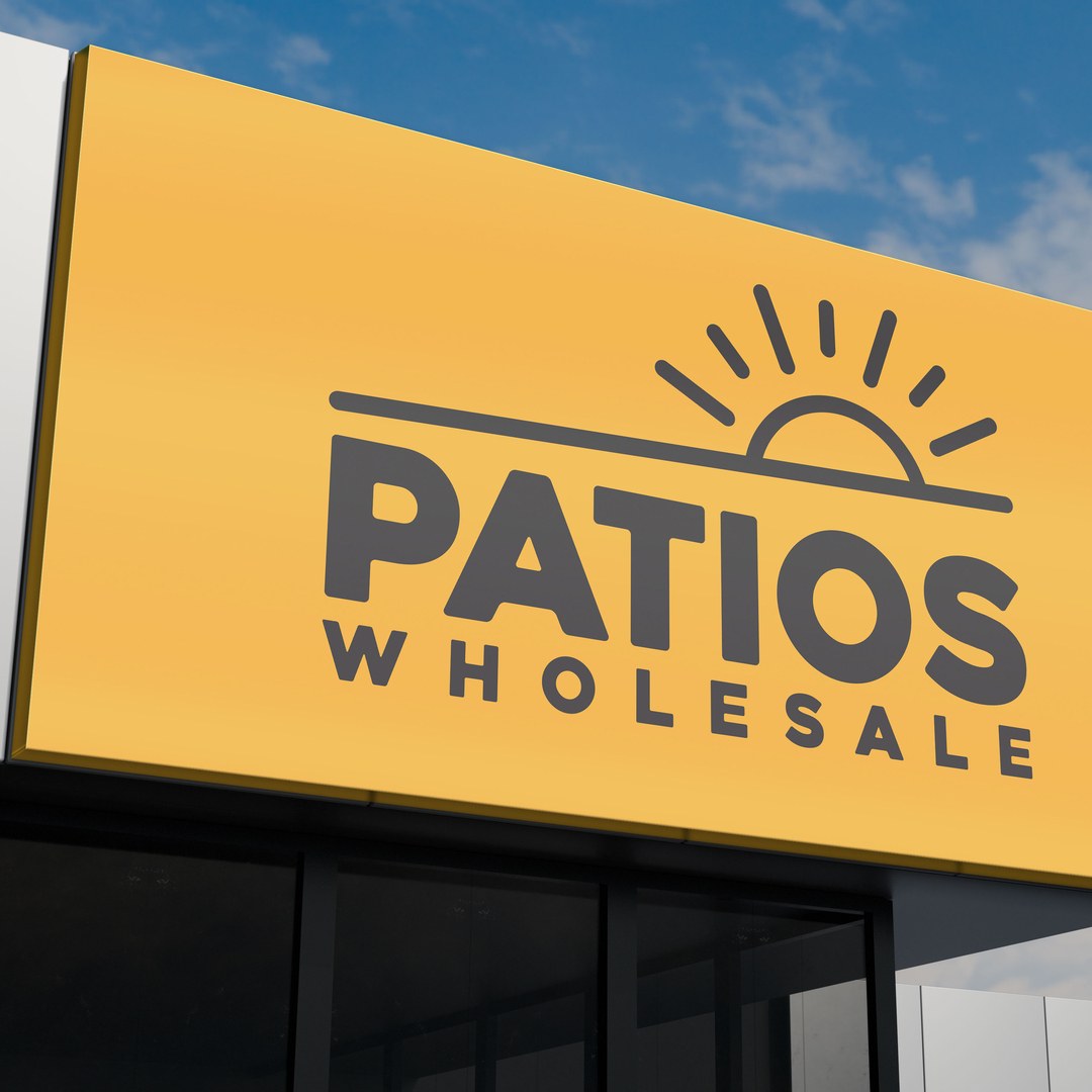 Patios Wholesale logo on a large yellow building sign